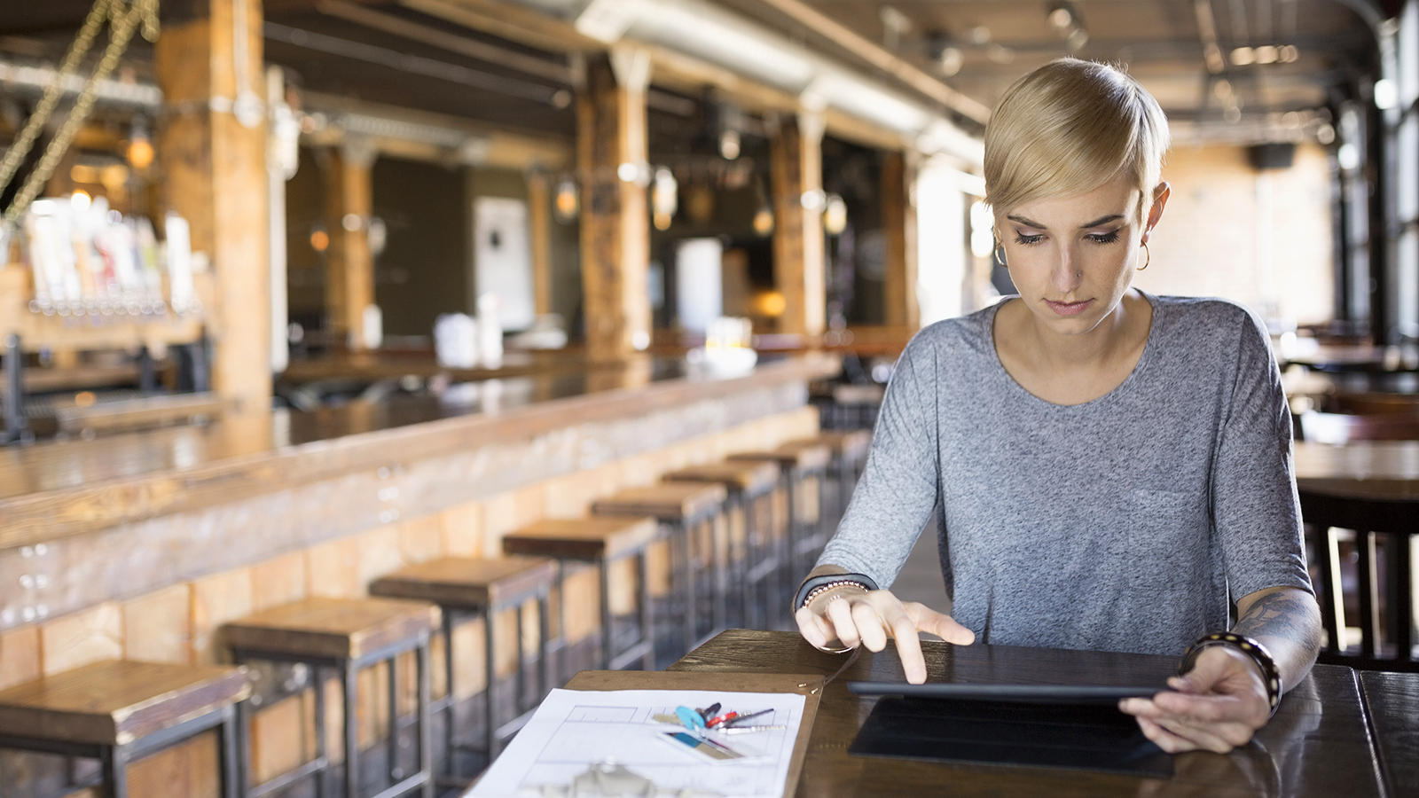 Female pub owner using tablet.