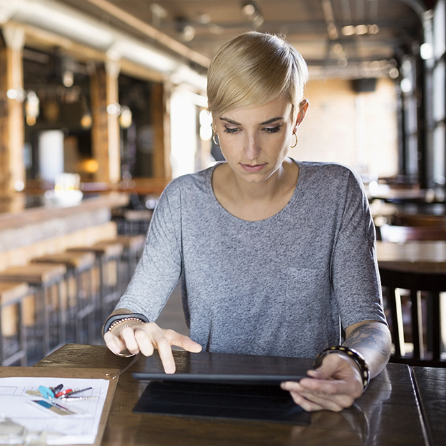 Female pub owner using tablet.