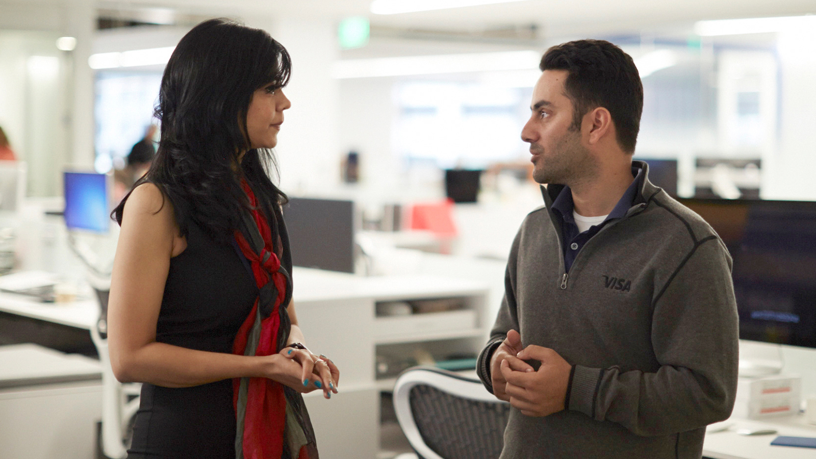 Woman and man discussing topic in office