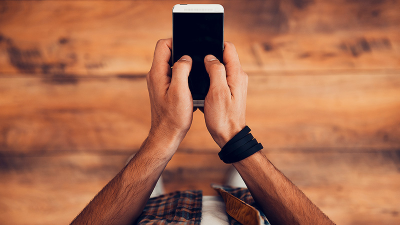 Marquee-VE-StayingInTouch-800x450 Hands holding a phone.