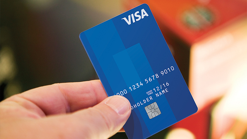 Marquee-VE-VisaCard-800x450 Person holding Visa chip card.
