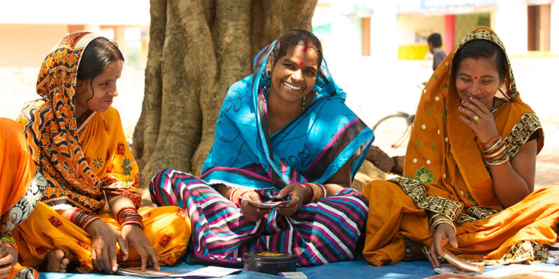 Indian women sitting outdoors