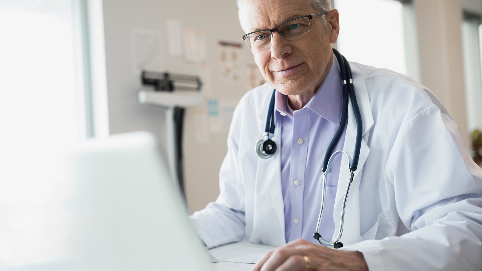 doc-laptop-1600x900 Doctor in office using laptop.