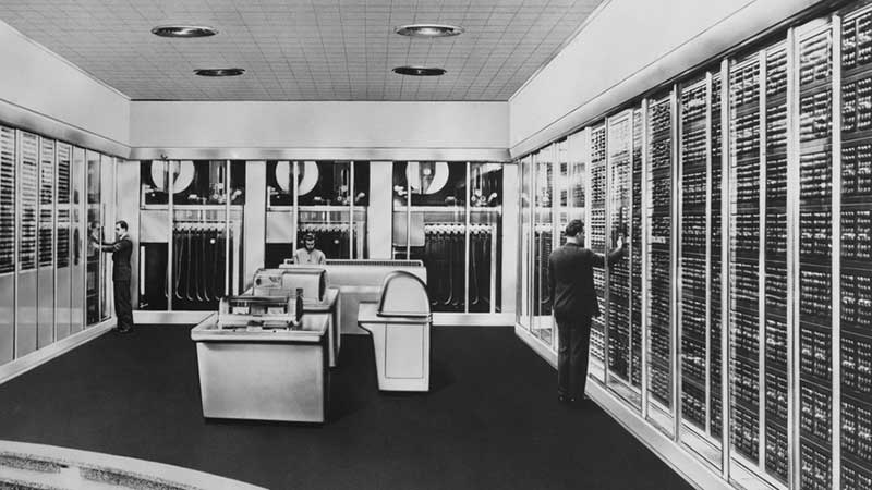 Historical photo of employees working in a computer room in the 1950s.