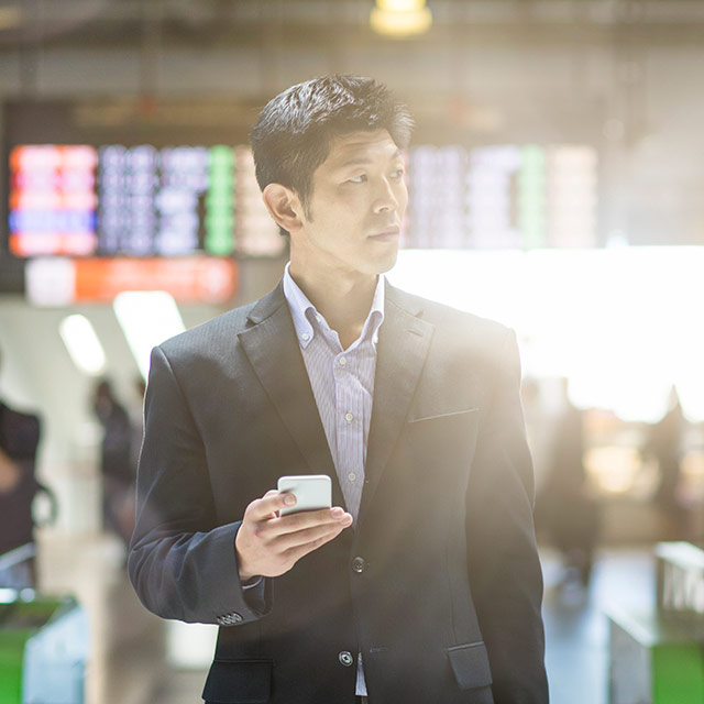 Man at the airport searching on mobile app