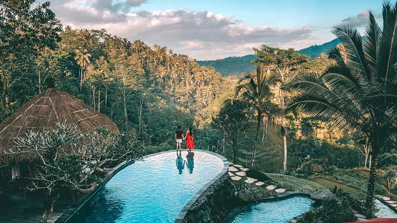 Two people enjoying the views in Bali on their trip, which they planned with Bali travel card from Visa.