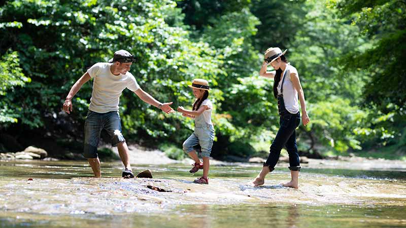 Family crossing a river