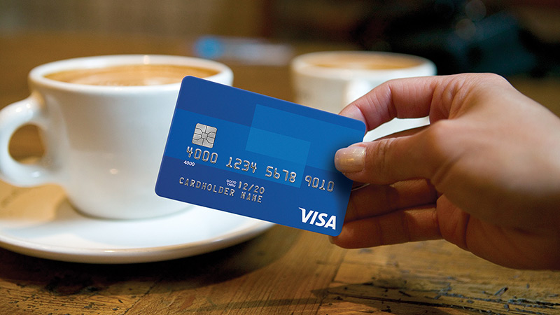 Customer paying for a coffee using a Visa credit card. Unexpected expenditures with company cards, such as eating out, necessitate good spend management protocols
