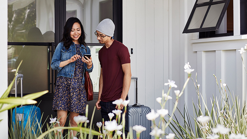 man and woman looking at a smartphone